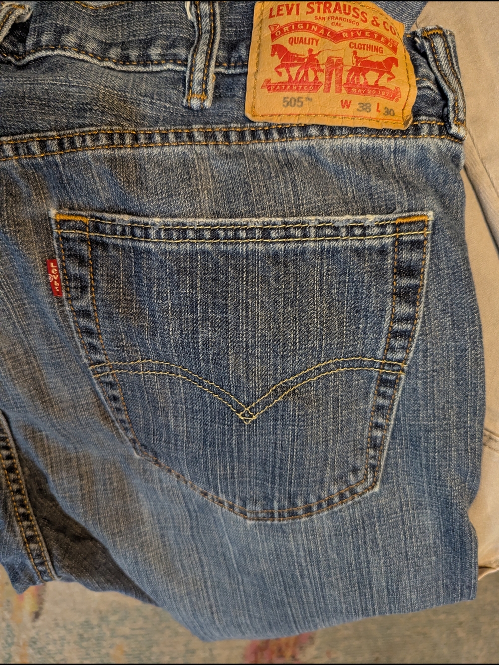 Levi's 505 blue denim jeans with tan stitching